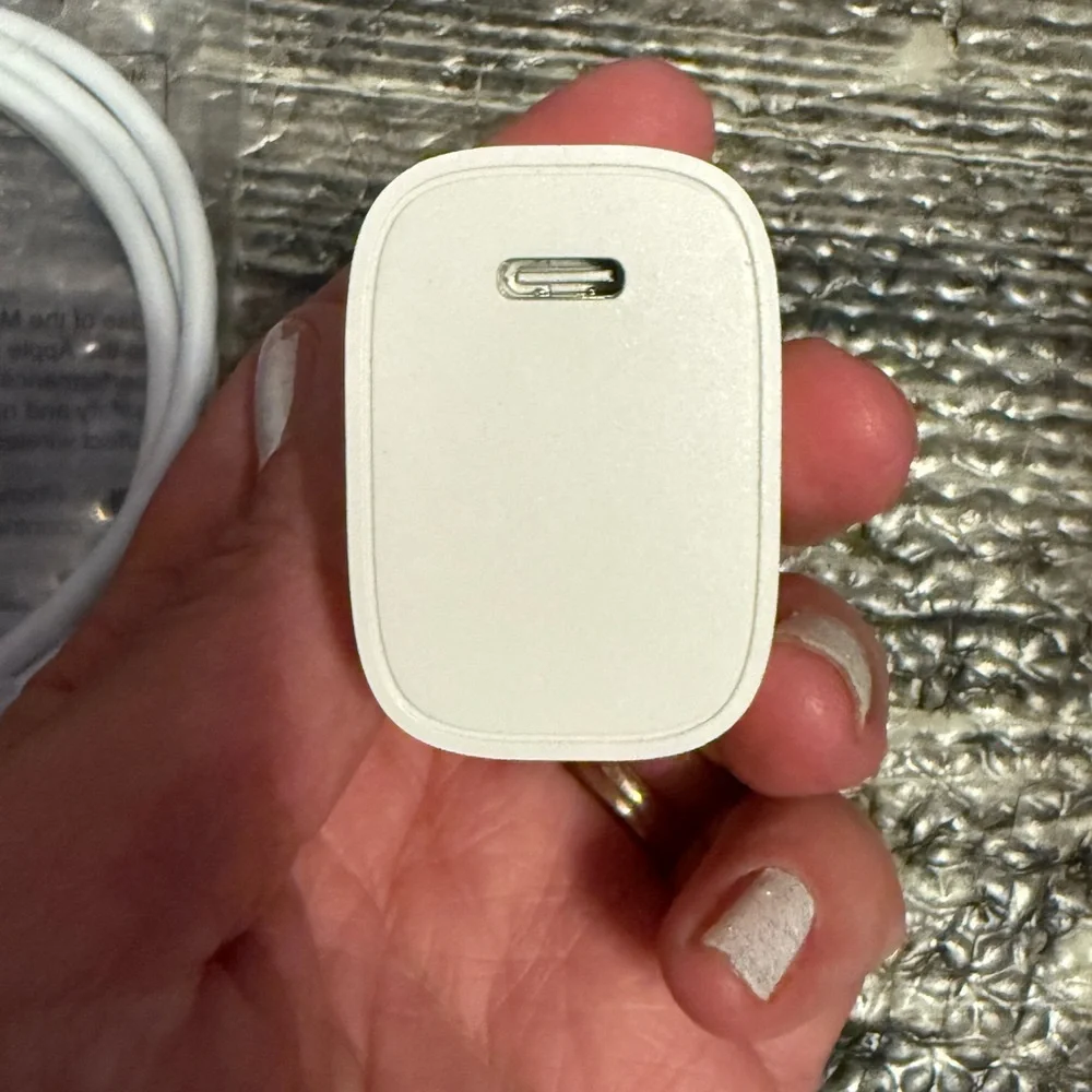 iPhone SE extra charger, SIM card and ejector tool.